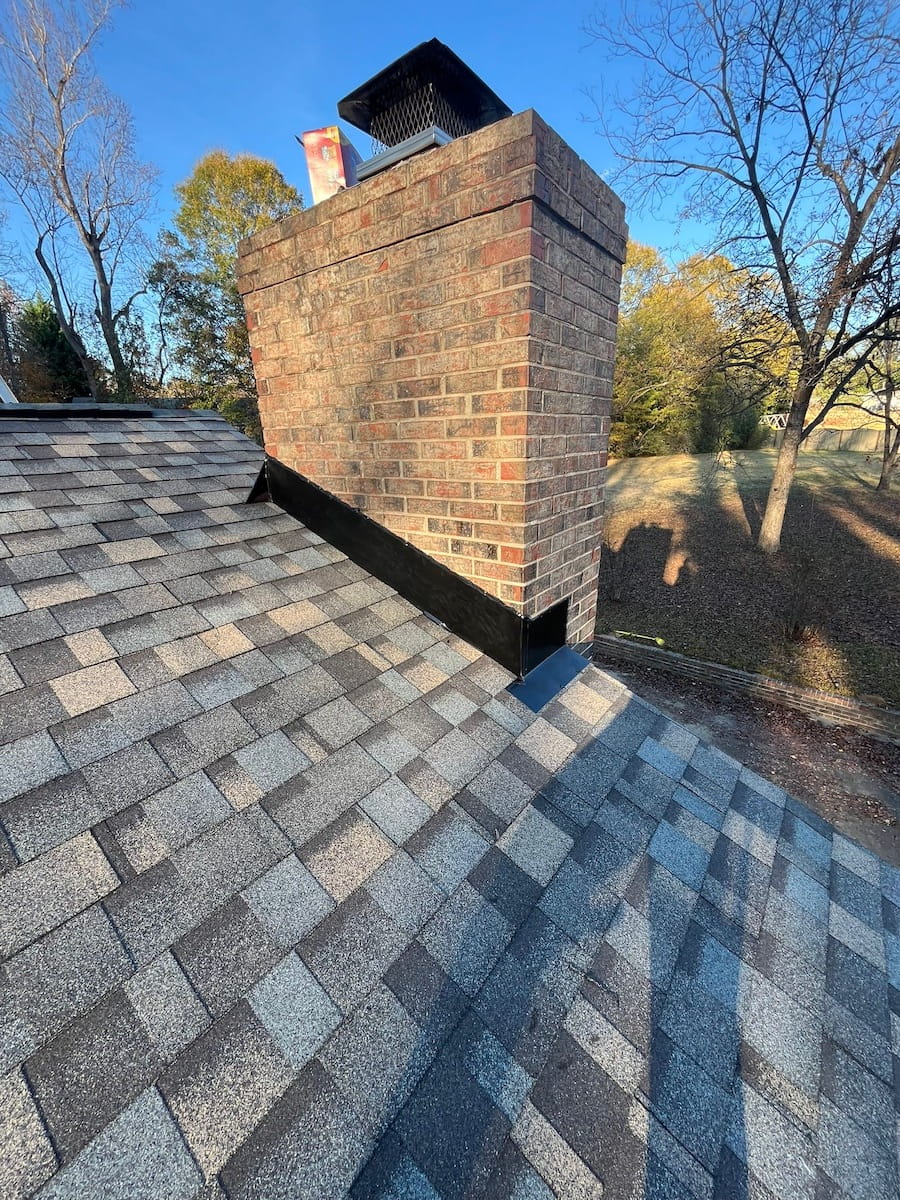 Chimney flashing installation on architectural shingle roof in Easley South Carolina