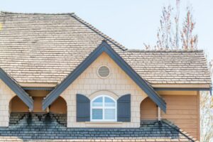 Residential home showcasing a steep roof pitch and asphalt shingle roof